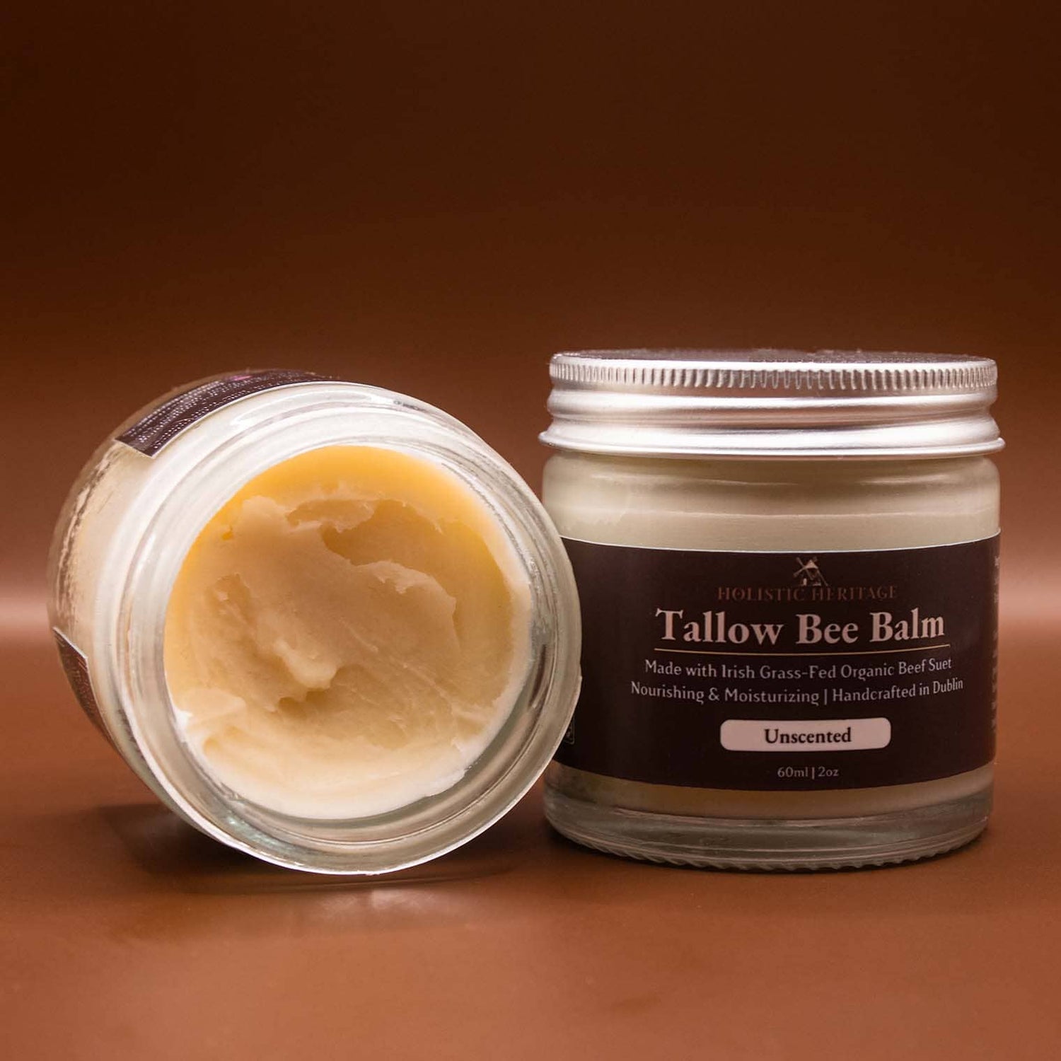 Holistic Heritage Unscented Tallow Bee Balm – open jar showing balm texture and closed labeled jar